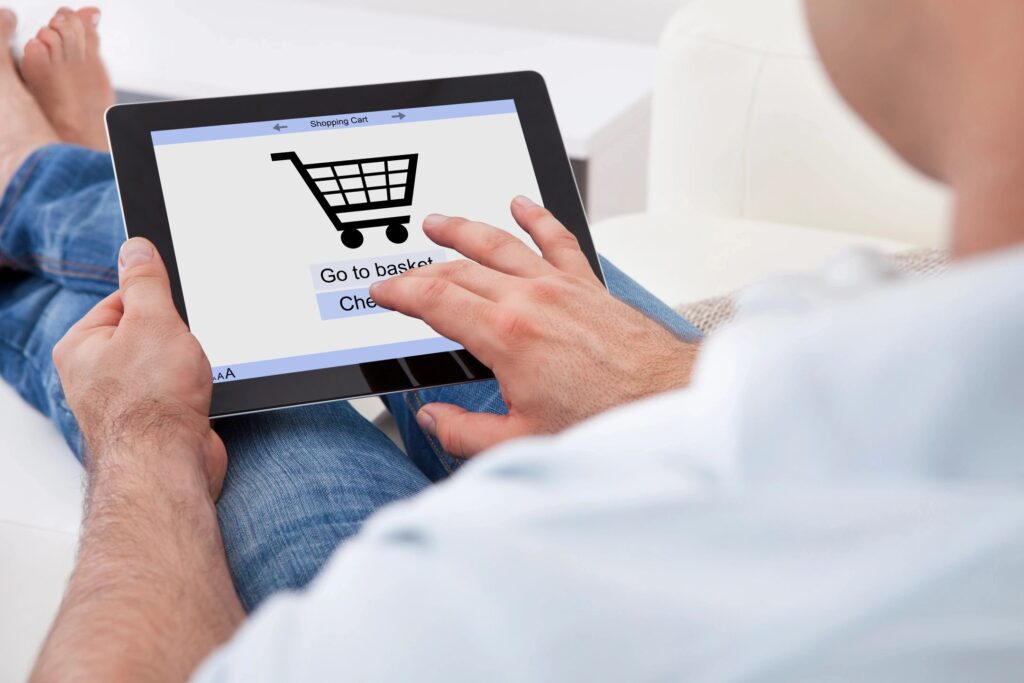 Person adding a purchase to their online cart