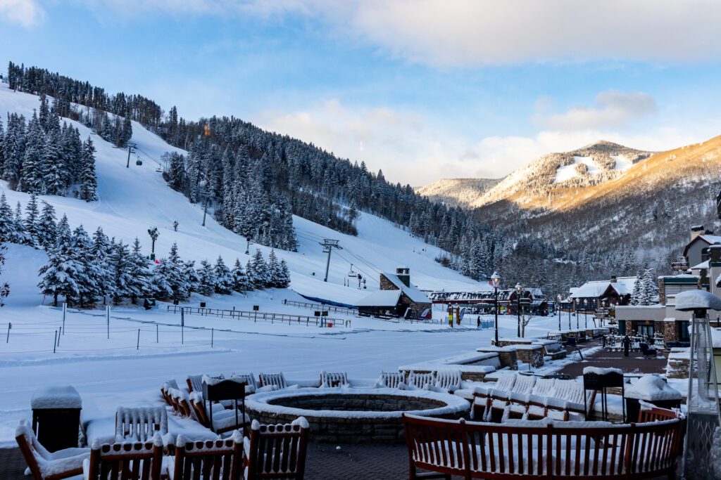 Snow-covered outdoor patio with mountain views and firepit at Park Hyatt Beaver Creek
