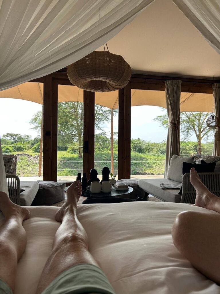 View from bed inside luxury tent at JW Marriott Masai Mara overlooking the Masai Mara reserve