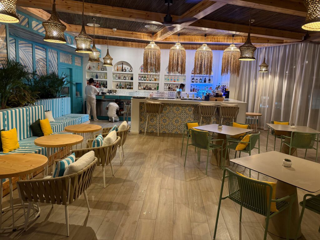 Hyatt Regency Malta rooftop bar with woven pendant lights and colorful seating