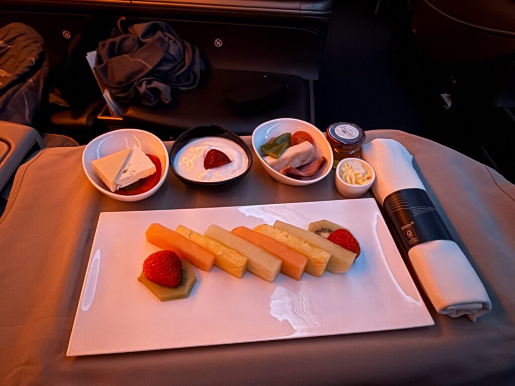 Sliced fruit served with yogurt, cheeses and cold meats before arrival.